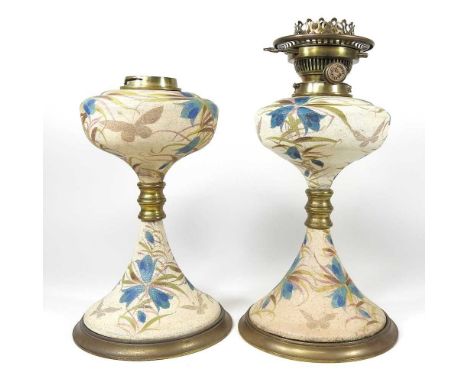 A pair of early 20th century pottery oil lamps, 30cm high (2)Overall appear to be undamaged, with light surface marks and wea