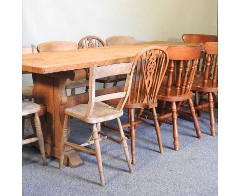 A large light oak refectory dining table, together with ten various dining chairs (11)225w x 83d x 79h cm