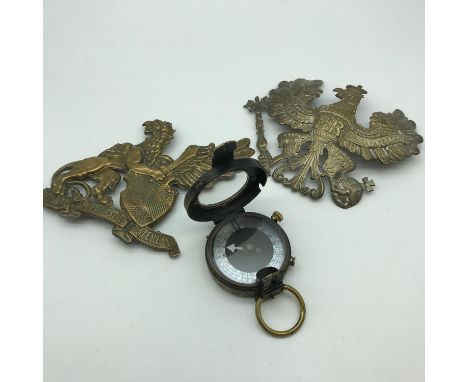 A lot of two German helmet badges together with a WW1 Verners pattern compass 