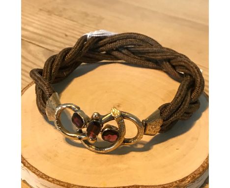 A Victorian mourning bangle created with hair, gold &amp; three large Amethyst/ ruby stones. 