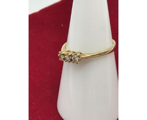 A 9ct gold ladies ring set with 3 diamond stones. Size M. 