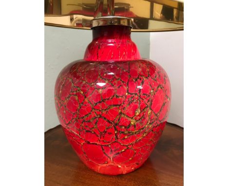 A Large ornate art glass table lamp, Very striking red, black and gold colours. Lamp base lights up. Styled with and industri