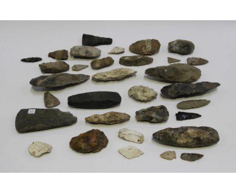 A collection of Mesolithic and Neolithic flint implements, including Tranchet and part polished axe heads, the majority with 