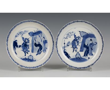 A pair of Chinese blue and white porcelain saucer dishes, mark of Chenghua but Kangxi period, each painted with an armoured w