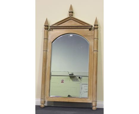 A modern limed oak wall mirror with an architectural pediment and arched bevel glass, flanked by rounded pilasters, approx 17