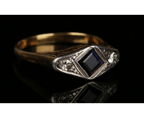 A gold, sapphire and diamond three stone ring, mounted with the square cut sapphire between two circular cut diamonds, detail