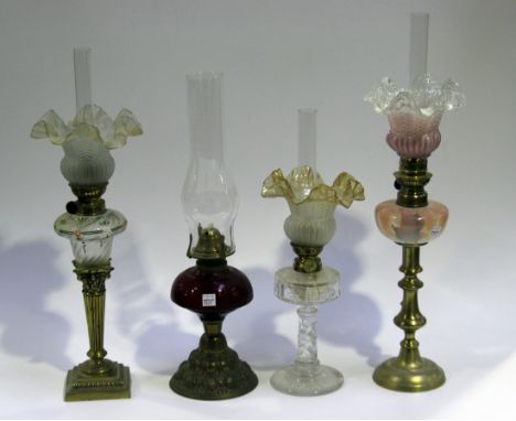 A late 19th/early 20th Century cut clear glass table oil lamp with matched glass shade, height approx 31cm, a vaseline glass 