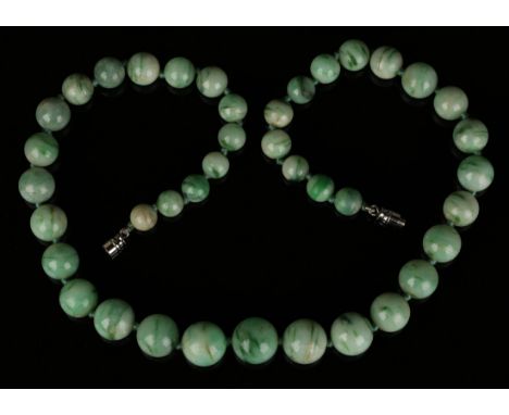 A single row necklace of graduated treated jade beads, on a screw clasp, length approx 48cm.