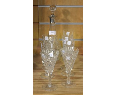 A cut glass decanter fitted with a silver collar, London 1929, and a matched stopper, a set of five Brierly champagne flutes,