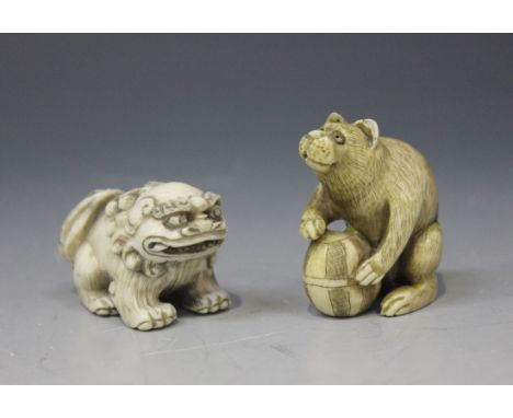 A Japanese carved ivory netsuke, Meiji period, modelled as a seated Buddhistic lion, signed, height approx 3.2cm, together wi