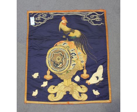 A Japanese silk embroidered fukusa, Meiji period, finely worked in coloured and gilt threads with a cockerel standing atop a 