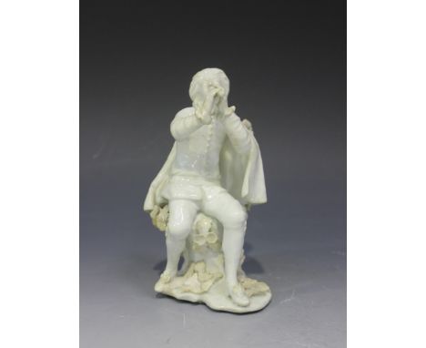 A Chelsea porcelain figure in the white of the Commedia dell'arte musician Scaramuzzi, mid-18th Century, modelled seated play