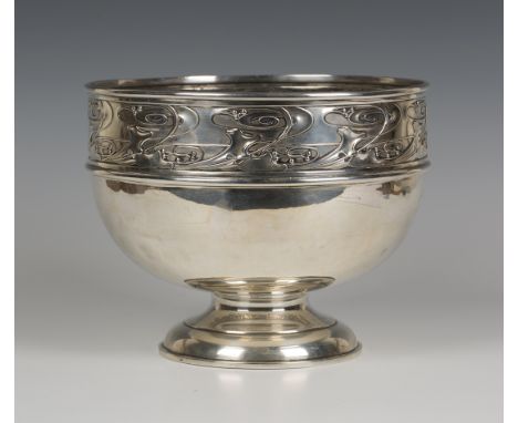 An Art Nouveau silver rose bowl, designed by Kate Harris, decorated in relief with a band of stylized scrolling leaves and be