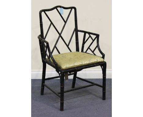 A 19th Century Chinese Chippendale style ebonized and gilt decorated elbow chair with faux bamboo back, arms and supports, he