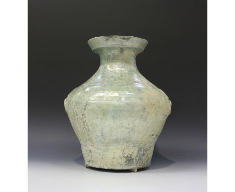 A Chinese lead glazed terracotta vase, Han dynasty (206 BC - 220 AD), the baluster body moulded in relief with a pair of mask