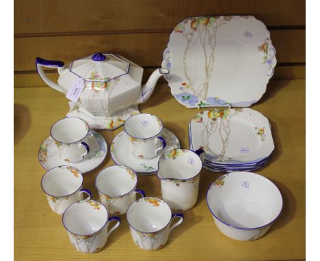 A Shelley Vincent shape part tea service, decorated with trees with autumn coloured leaves within blue rims, comprising teapo