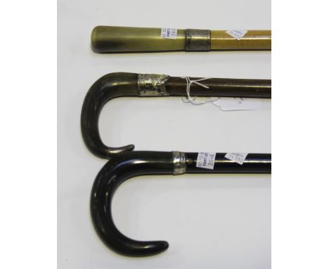 A late 19th/early 20th Century rhino horn handled walking stick with silver mounts, length approx 88cm, together with two oth