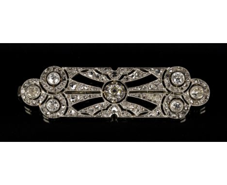 A white gold and diamond brooch in a pierced rectangular geometric shaped design, mounted with cushion shaped and rose cut di