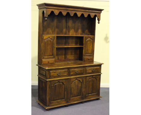 A late 20th Century reproduction hardwood dining room suite, comprising a refectory table, length approx 215cm, two ladder ba
