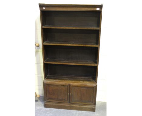 A George V oak Globe Wernicke style four-section bookcase, fitted with a cupboard to base, height approx 172cm, width approx 