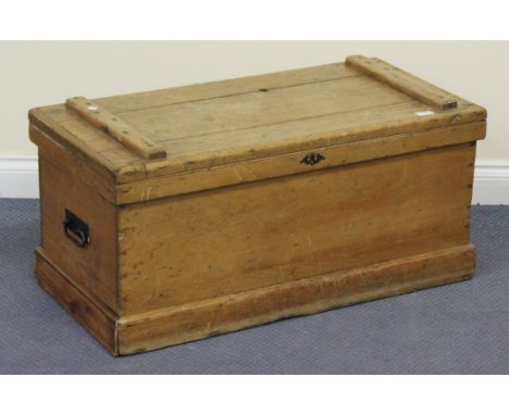 A Victorian stripped pine trunk with carrying handles, on a plinth base, height approx 43cm, width approx 89cm.