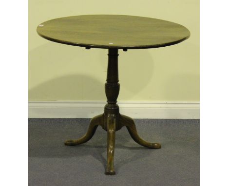 A 19th Century oak circular tip-top wine table, raised on a turned stem and tripod legs, height approx 71cm, diameter approx 