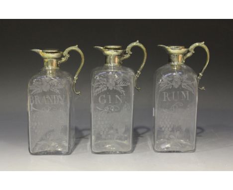 A set of three late 19th Century plate mounted clear glass square decanters, each fitted with a plated collar, pouring lip an