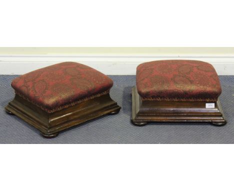 A pair of Victorian mahogany cushion form foot stools on flattened bun feet, height approx 20cm, width approx 42cm.