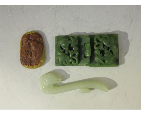 A Chinese pale celadon jade belthook, late 20th Century, of typical serpentine form with ram's head terminal, length approx 9