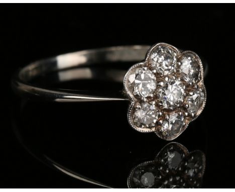 An 18ct white gold, platinum and diamond set seven stone cluster ring, mounted with cushion shaped diamonds, detailed '18ct &