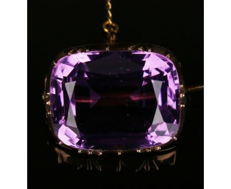 A Victorian gold and amethyst single stone brooch, mounted with a cushion shaped amethyst, width approx 2.2cm, fitted with a 