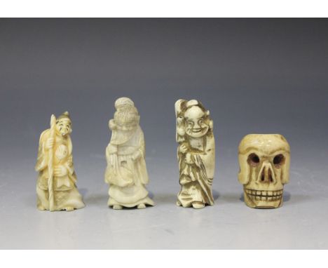 A Japanese staghorn netsuke, Meiji period, carved as a sage holding a lotus stem over his shoulder, height approx 6.5cm, toge