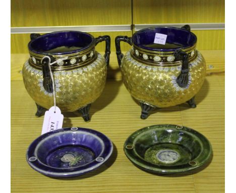 A pair of Royal Doulton stoneware jardinières, each in the form of a cauldron, the bulbous body with gilt whorl decoration, f