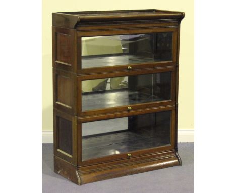 A George V mahogany three section Globe Wernicke style bookcase, the interior with mirrored backs, height approx 113cm, width