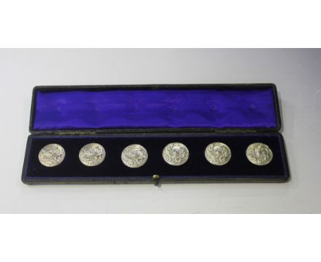 A set of six Edwardian silver circular buttons, each decorated in relief with scrolling stems of lily-of-the-valley, Birmingh