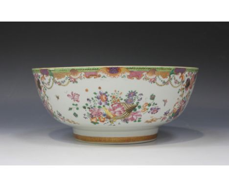 A Chinese famille rose export porcelain punch bowl, Qianlong period, finely painted and gilt with shells and flowers within s