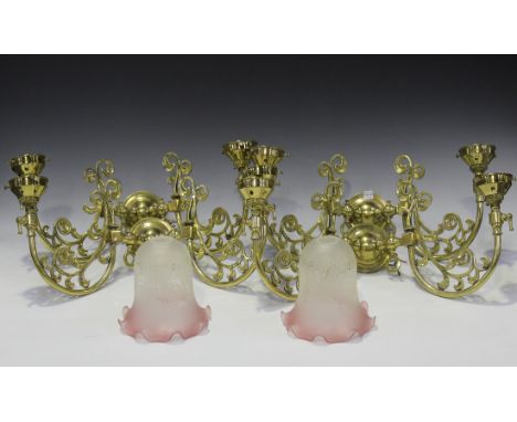 A 20th Century Edwardian style brass five branch ceiling light, fitted with pink frosted glass shades supported by foliate sc