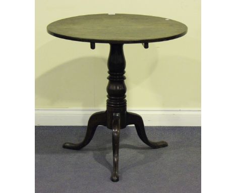 A 19th Century oak circular tip-top wine table, raised on a turned column and tripod cabriole legs, height approx 74cm, diame