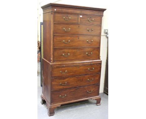 A George III mahogany chest-on-chest, the dentil moulded pediment above two short and three long drawers, the base fitted wit