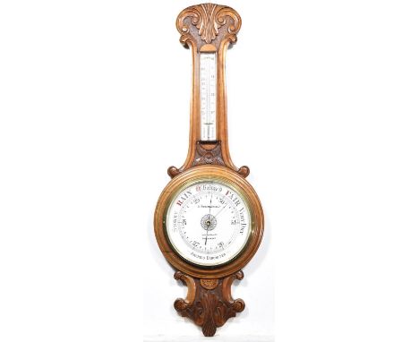 A large and impressive Victorian carved oak banjo wall barometer by E Robinson & Co, The Square, ShrewsburyHaving a leaf and 