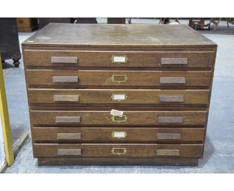 An early 20th Century oak map/plan chest The two piece chest with six drawers each applied with wooden handles and gilt metal