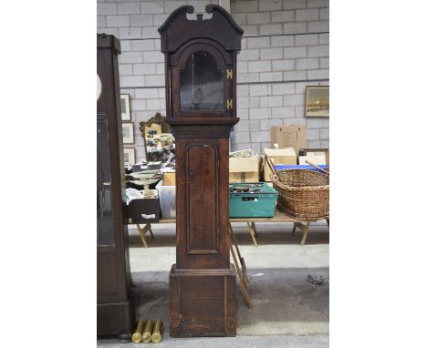 A primitive oak longcase clock case, early 17th CenturyHaving a twin swan neck pediment above a break arched glazed door flan