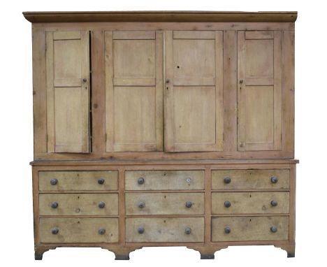 An impressive 19th Century pine house keepers cupboard,With a moulded cornice above four cupboard doors enclosing an arrangem