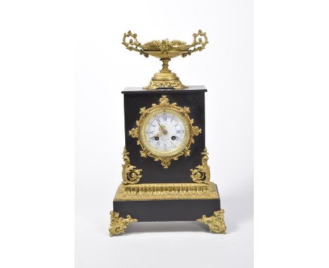 A late 19th Century French ormolu and slate mantle clockThe rectangular slate clock case surmounted with a two-handled ormolu