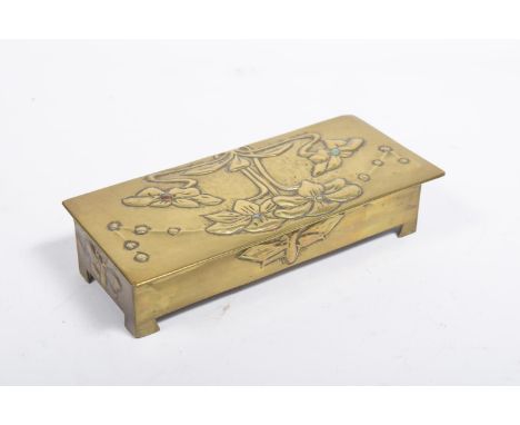 An early 20th Century Art Nouveau brass cigarette boxThe rectangular hinged lid embossed with stylised flowers and stone roun