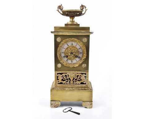 A late 19th Century French gilt metal mantle clockThe slender architectural case raised on foliate bracket feet with pierced 