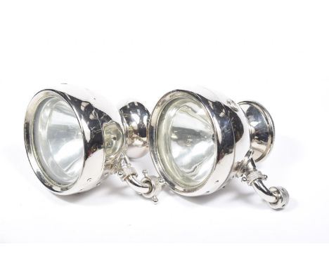 A pair of vintage chromed car lampsEach lamp having a circular rear view mirror applied to the bank of the lamp along with a 