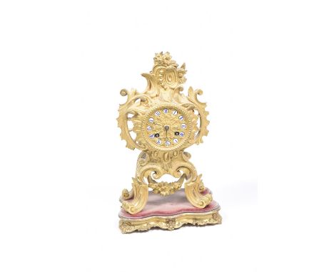 A late 19th, early 20th Century French ormolu mantle clock The scrolling leafy openwork case enclosing the 8cm dial applied w