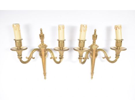 A pair of Regency style ormolu two branch wall light fittings, early 20th CenturyEach with an urn shaped finial above scrolli