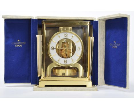 A Jaeger-Lecoultre "Atmos" clock The brass case four glass clock revealing internal workings and white enamel chaptering with